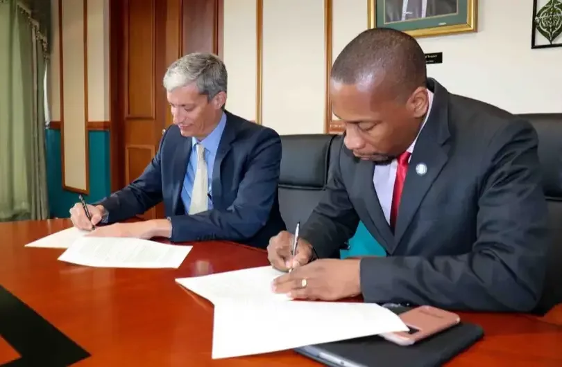 Rawdon Adams and Governor Timothy N J Antoine signing MOU